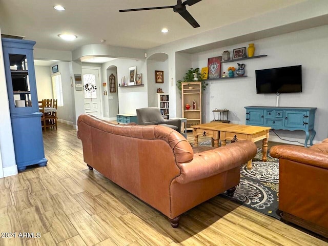 living room featuring light hardwood / wood-style flooring and ceiling fan