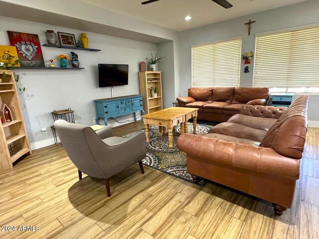 living room with light hardwood / wood-style flooring and ceiling fan