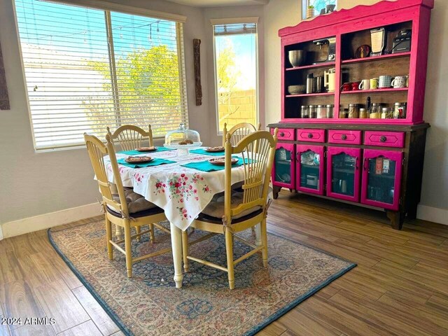 dining space with hardwood / wood-style floors