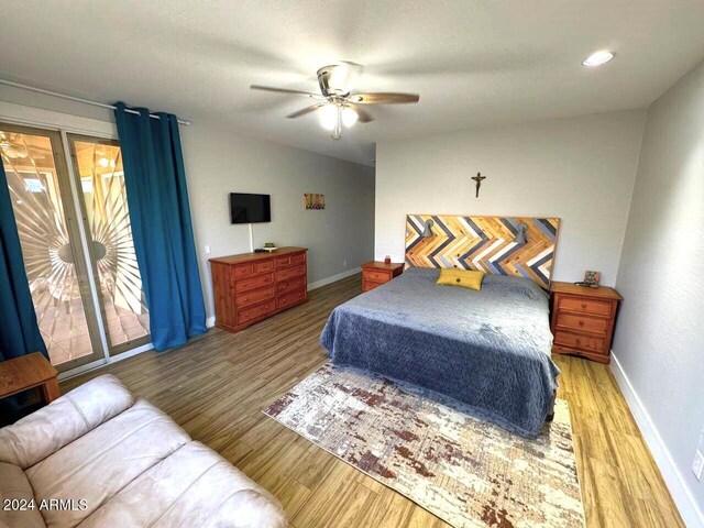 bedroom featuring hardwood / wood-style flooring, ceiling fan, vaulted ceiling, and access to outside