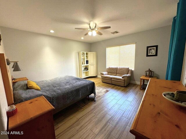 bedroom with hardwood / wood-style flooring and ceiling fan