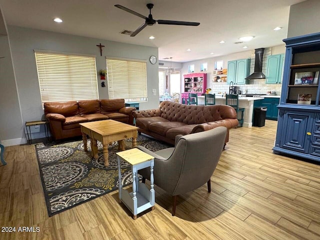 living room featuring light hardwood / wood-style floors and ceiling fan