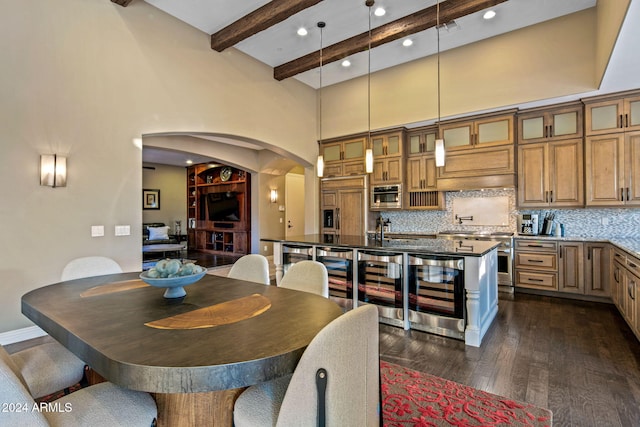 dining space featuring dark hardwood / wood-style flooring, beamed ceiling, a high ceiling, and beverage cooler