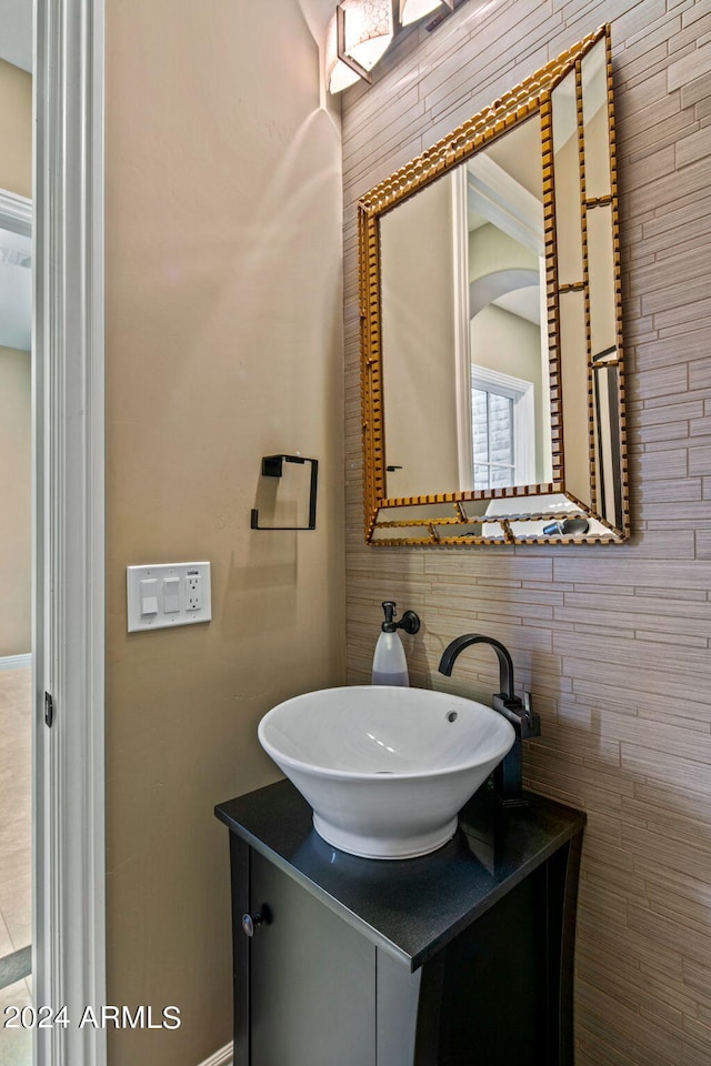 bathroom with tile walls and vanity