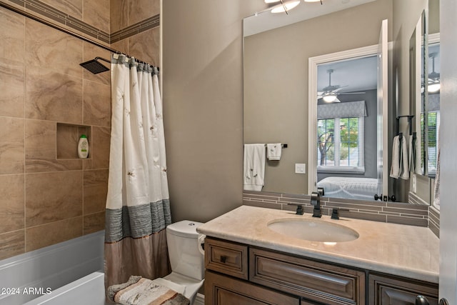 full bathroom featuring toilet, shower / bath combo with shower curtain, vanity, and ceiling fan