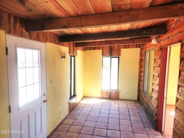 tiled spare room with beamed ceiling and wood ceiling