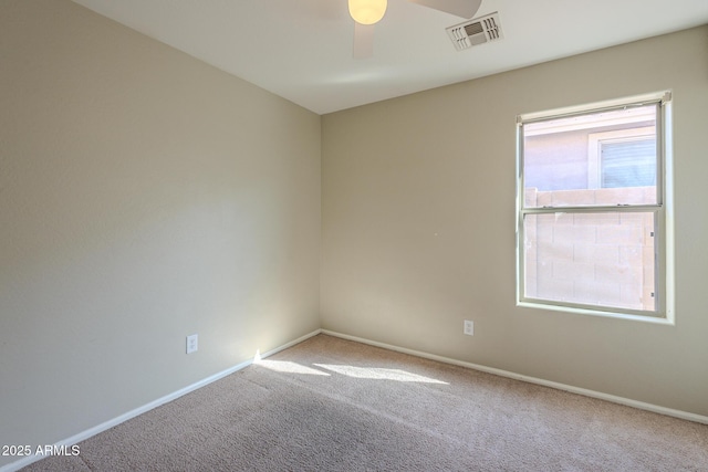 spare room featuring carpet flooring and ceiling fan