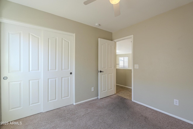 unfurnished bedroom with light carpet, a closet, and ceiling fan