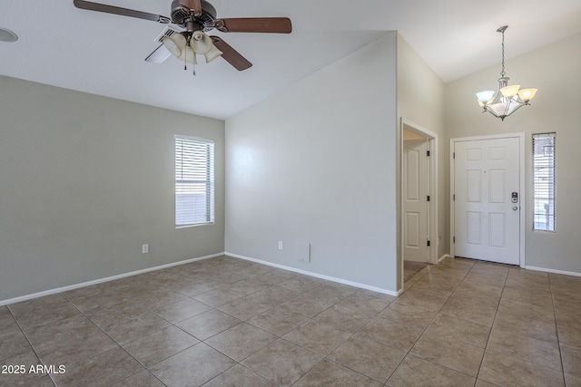 tiled foyer entrance with lofted ceiling and ceiling fan with notable chandelier