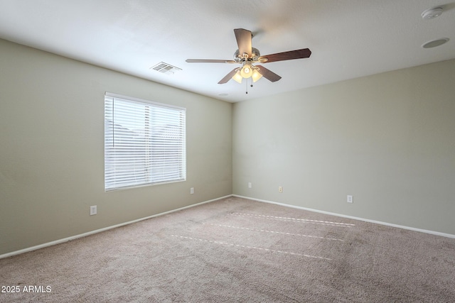 unfurnished room featuring light colored carpet and ceiling fan