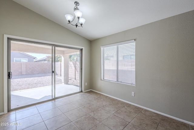 empty room with light tile patterned flooring, lofted ceiling, and a notable chandelier