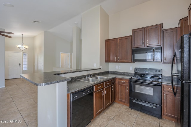 kitchen with kitchen peninsula, sink, black appliances, light tile patterned floors, and pendant lighting