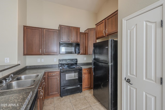 kitchen featuring light tile patterned flooring, sink, and black appliances