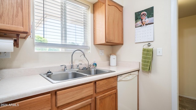 kitchen with dishwasher, sink, and light brown cabinets