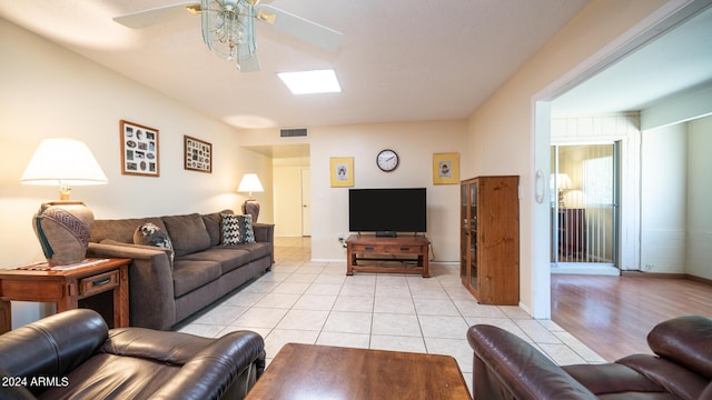 living room featuring ceiling fan and light tile patterned floors
