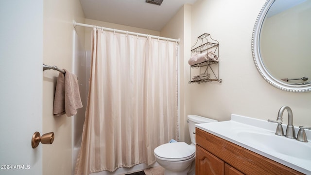 bathroom featuring a shower with curtain, vanity, and toilet