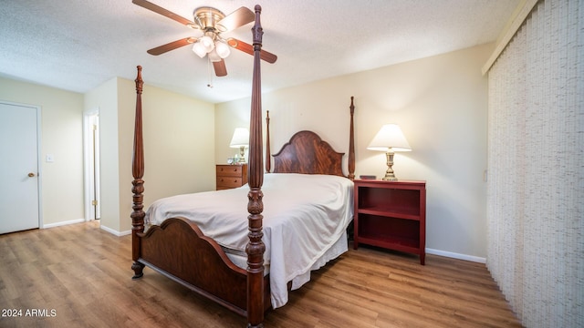 bedroom featuring wood-type flooring, ceiling fan, and a textured ceiling