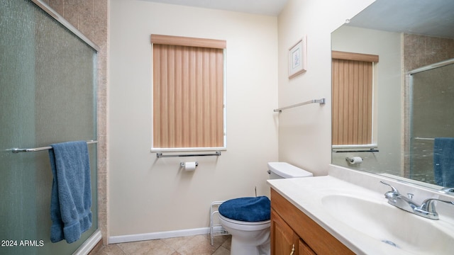 bathroom featuring vanity, toilet, tile patterned flooring, and a shower with door