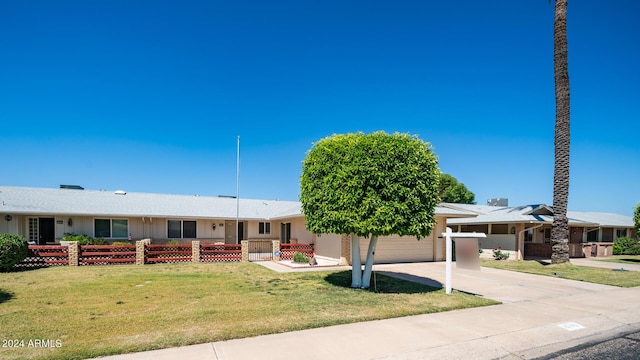 single story home with a garage and a front lawn