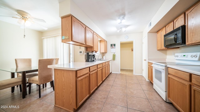 kitchen featuring white range with electric stovetop, sink, light tile patterned floors, ceiling fan, and kitchen peninsula