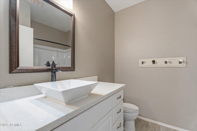 9600 N 96th St Unit 263, Scottsdale, AZ 85258 - bathroom with vanity, toilet, and baseboards