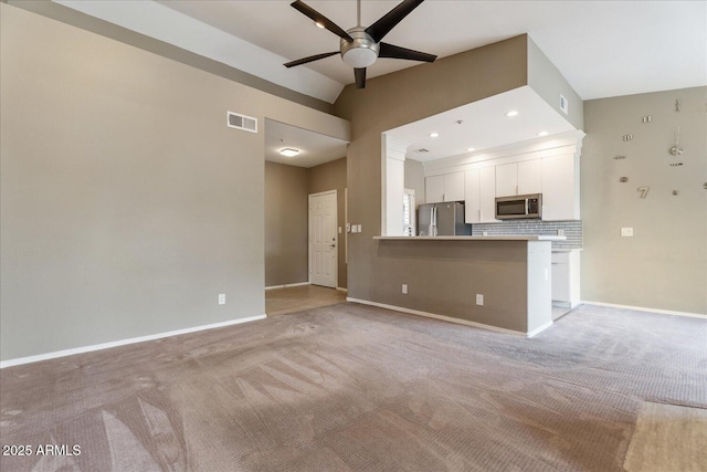 9600 N 96th St Unit 263, Scottsdale, AZ 85258 - kitchen featuring stainless steel appliances, a ceiling fan, white cabinetry, light colored carpet, and lofted ceiling