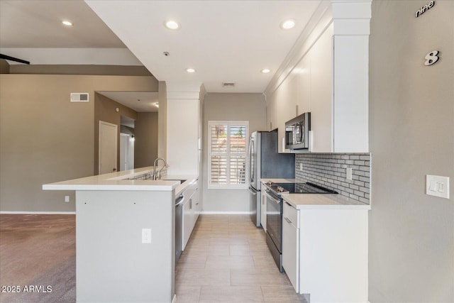 9600 N 96th St Unit 263, Scottsdale, AZ 85258 - kitchen featuring stainless steel appliances, a peninsula, baseboards, white cabinetry, and backsplash