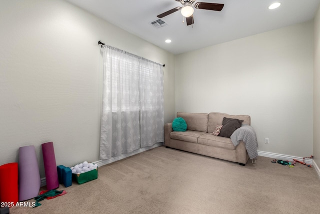 living area with a ceiling fan, light colored carpet, visible vents, and recessed lighting