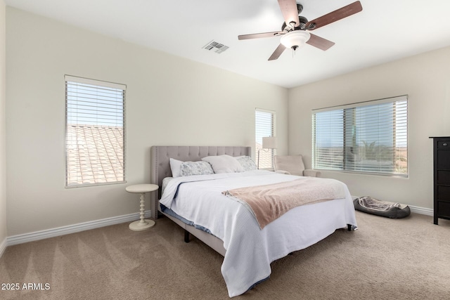 bedroom with carpet floors, visible vents, baseboards, and ceiling fan