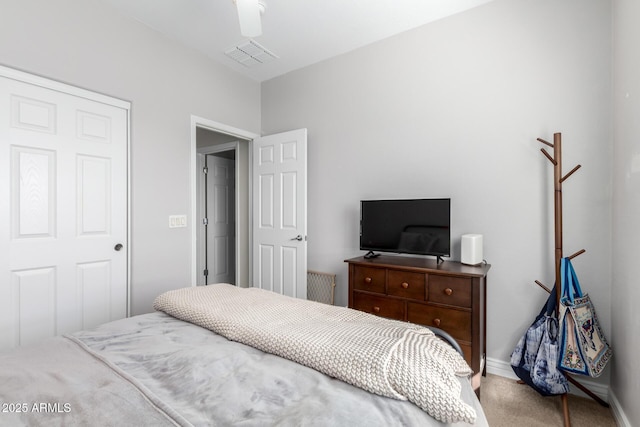 bedroom featuring baseboards, visible vents, and light colored carpet