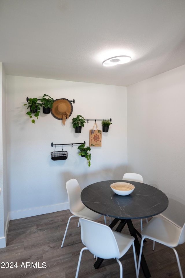 dining space with dark hardwood / wood-style flooring