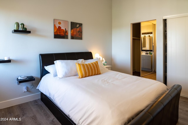 bedroom with ensuite bath, a closet, and dark wood-type flooring