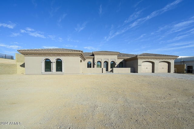 mediterranean / spanish-style house with a garage