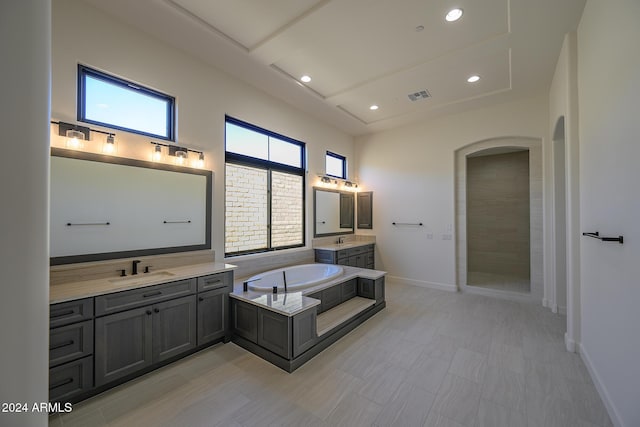 13272 E Ln Junta Rd, Scottsdale, AZ 85255 - bathroom featuring two vanities, a bath, recessed lighting, and baseboards