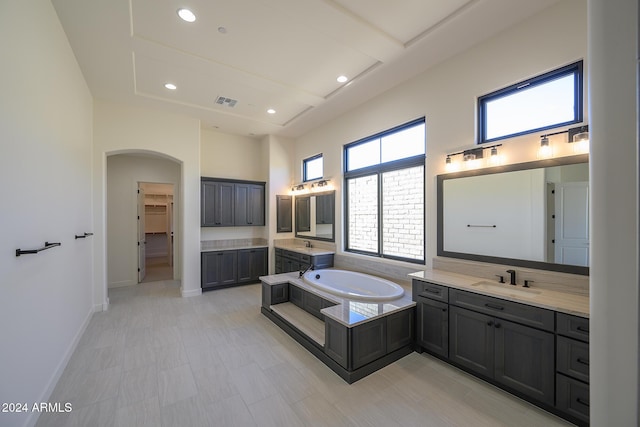 13272 E Ln Junta Rd, Scottsdale, AZ 85255 - full bath with a high ceiling, a bath, two vanities, baseboards, and a spacious closet