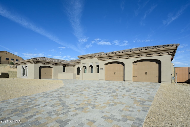 mediterranean / spanish house with a garage