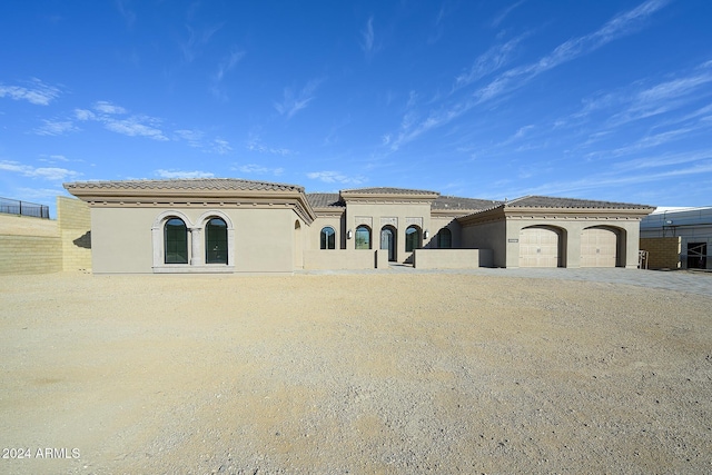 13272 E Ln Junta Rd, Scottsdale, AZ 85255 - mediterranean / spanish-style house with a garage, stucco siding, a tile roof, and driveway