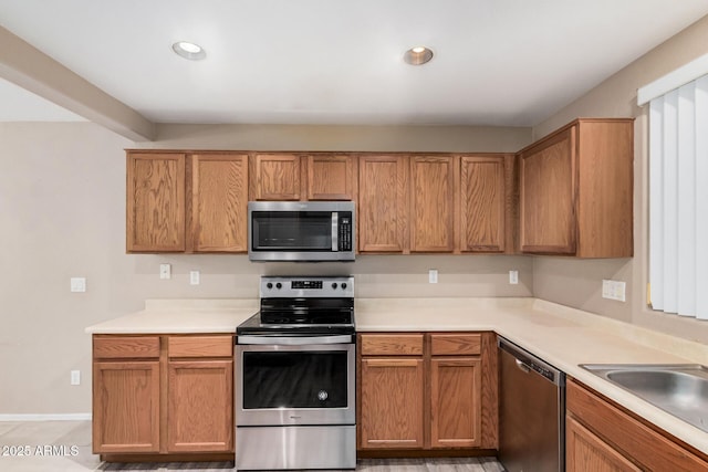 3719 W Carson Rd, Phoenix, AZ 85041 - kitchen with appliances with stainless steel finishes, light countertops, recessed lighting, and brown cabinets
