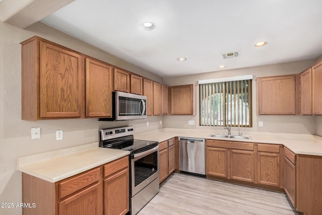 3719 W Carson Rd, Phoenix, AZ 85041 - kitchen with appliances with stainless steel finishes, light wood-style floors, light countertops, and recessed lighting