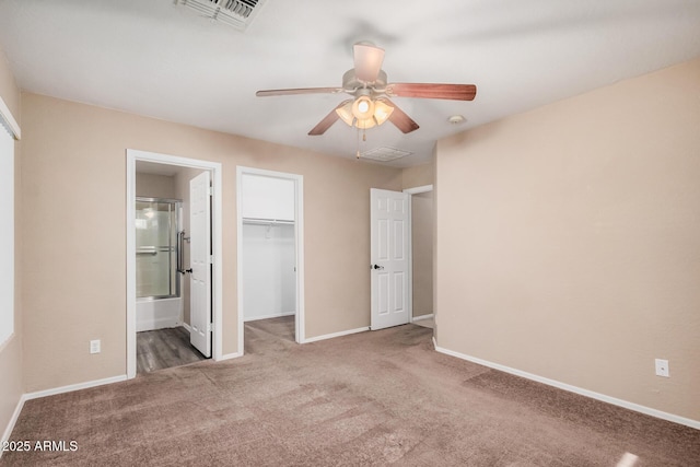 3719 W Carson Rd, Phoenix, AZ 85041 - unfurnished bedroom featuring carpet, a closet, ensuite bath, ceiling fan, and a walk in closet