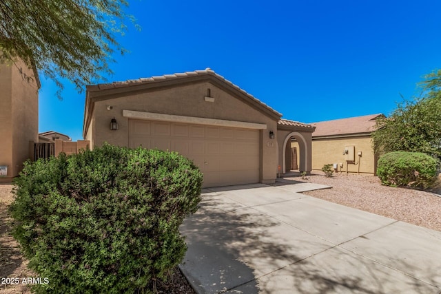 3719 W Carson Rd, Phoenix, AZ 85041 - view of front of property with a garage, stucco siding, a tile roof, and concrete driveway