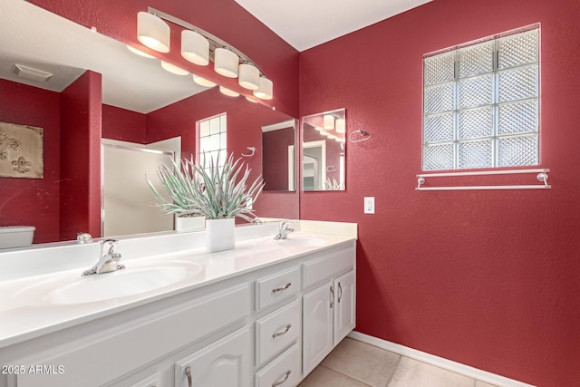 bathroom featuring tile patterned floors, toilet, an enclosed shower, and vanity