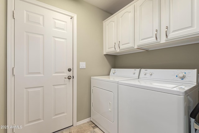 washroom with washing machine and dryer and cabinets