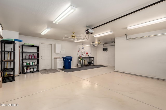 garage featuring a garage door opener and ceiling fan