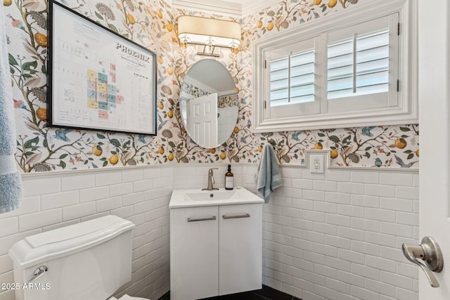 3201 E Colter St, Phoenix, AZ 85018 - bathroom featuring wallpapered walls, vanity, wainscoting, and tile walls