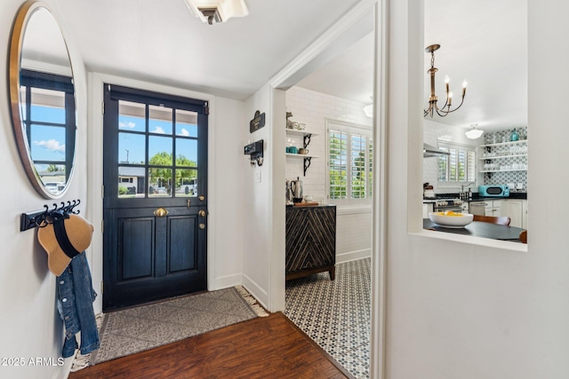 3201 E Colter St, Phoenix, AZ 85018 - entryway with healthy amount of natural light, a chandelier, and wood finished floors