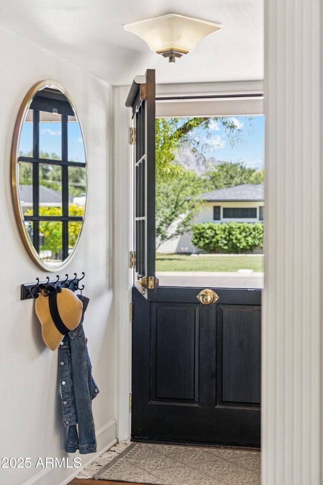 3201 E Colter St, Phoenix, AZ 85018 - doorway to outside featuring baseboards