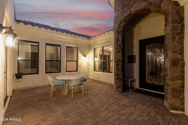 patio terrace at dusk featuring outdoor dining space