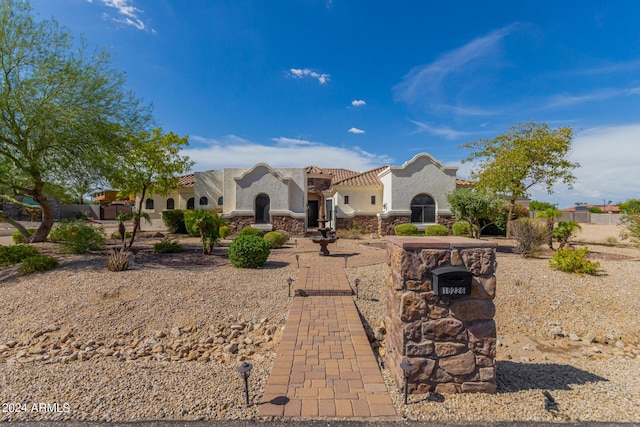 view of front of property with stucco siding and a tile roof
