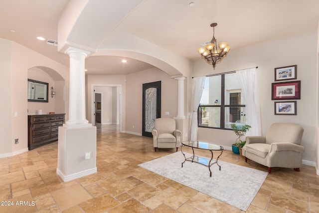 sitting room with stone tile floors, ornate columns, and visible vents